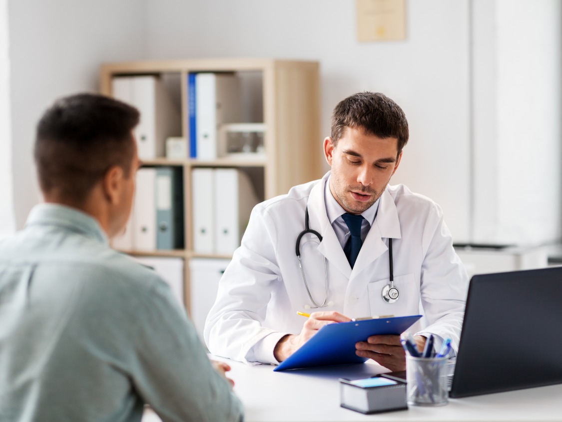 Pharmacist assisting customer at modern pharmacy counter